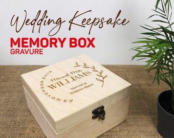 May include: A light wood keepsake box with an engraved inscription that reads "23 November 2019 Mr and Mrs WILLIAMS Married at Williams Manor".