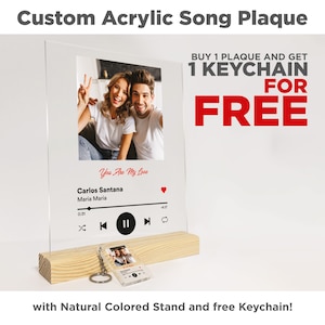 May include: Custom acrylic song plaque with a photo of a couple, a music player design, and the text "You Are My Love", "Carlos Santana", and "Maria Maria". The plaque is on a wooden stand and includes a free keychain.