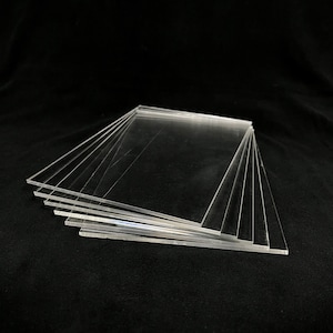 May include: A stack of clear acrylic sheets, likely for crafting or DIY projects.