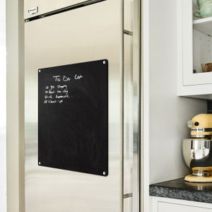 May include: A black chalkboard with a white to-do list written on it. The list includes "go shopping", "feed the dog", "do homework", and "clean up".