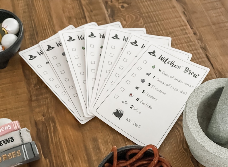 May include: A set of printable Halloween witch's brew recipe cards with a checklist of ingredients and a cauldron illustration. The ingredients include cups of snake venom, a scoop of magic dust, skeletons, spiders, eye balls, and mice.