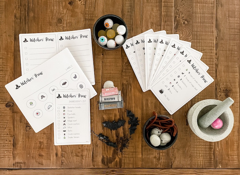 May include: A Halloween-themed game with a witch's brew theme. The game includes a checklist of ingredients for the brew, such as spider webs, eyeballs, and bats. There are also cards with checkboxes and a mortar and pestle.