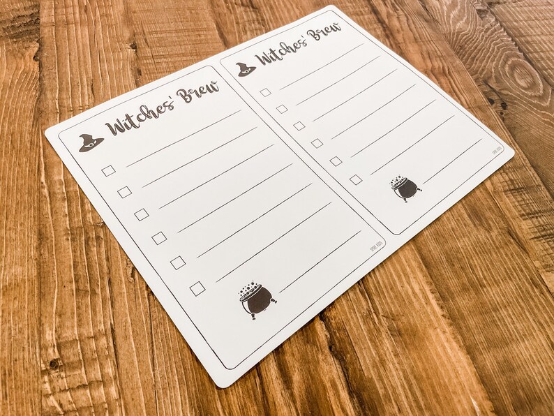 May include: A white checklist with the text "Witches' Brew" at the top. The checklist has a witch's hat and cauldron graphic. There are blank lines with checkboxes next to each line.