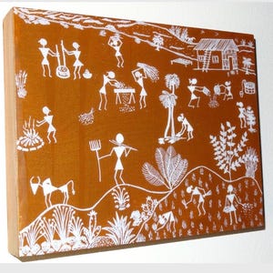 May include: A rectangular artwork featuring a rural scene with white figures against a brown background. The artwork depicts people engaged in various activities, including farming, cooking, and tending to livestock. The style is reminiscent of folk art.