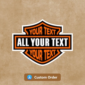 May include: A custom sticker design in a shield shape, with black and orange detailing. The text "YOUR TEXT" is at the top and bottom, with "ALL YOUR TEXT" in the centre. The sticker has a white border and a brown background.