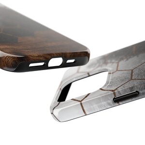 May include: Two phone cases, one with a wood grain pattern and the other with a white and gray geometric pattern with gold accents.