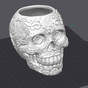 May include: A white, skull-shaped planter with detailed floral and swirl patterns. The open top suggests it's designed for holding plants or other items. The detailed carving gives it a unique, artistic appearance.