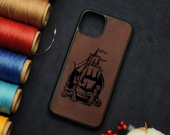 May include: A brown leather phone case with a black silhouette of a ship with an octopus wrapped around it.