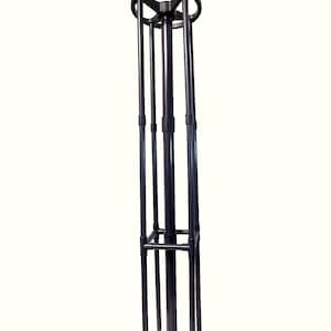 May include: A tall, black metal display stand. It features a circular top, a star-shaped base, and multiple vertical supports. A square frame is positioned near the base. The design is modern and minimalist.
