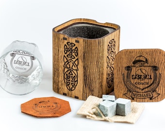 May include: Personalized whiskey gift set with a wooden box, a glass, a leather coaster, a bag of whiskey stones, and a wooden coaster. The box and coasters are engraved with the text "Baseball Coach Michael".