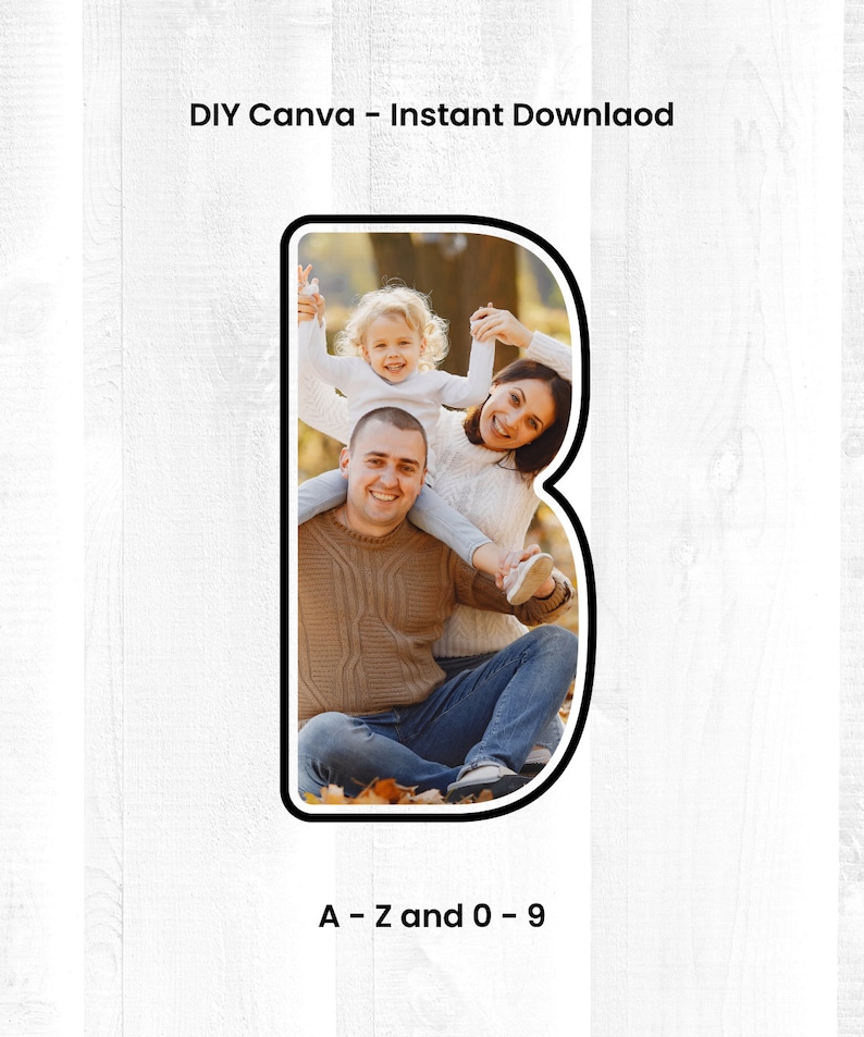 May include: A family of three poses for a photo in a letter B shape. The family is sitting on the ground with leaves around them. The father is wearing a brown sweater and blue jeans. The mother is wearing a white sweater and blue jeans. The daughter is wearing a pink shirt and white pants. The letter B is black and white.
