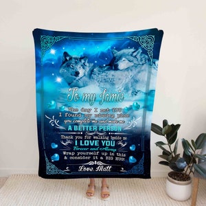 May include: A blue and white blanket with a couple of wolves cuddling. The blanket has a message that says "To my Jamie, The day I met you I found my missing piece you complete me and make me a better person... Thank you for walking beside me I love you Forever and Always Wrap yourself up in this & consider it a big hug! Love, Matt"