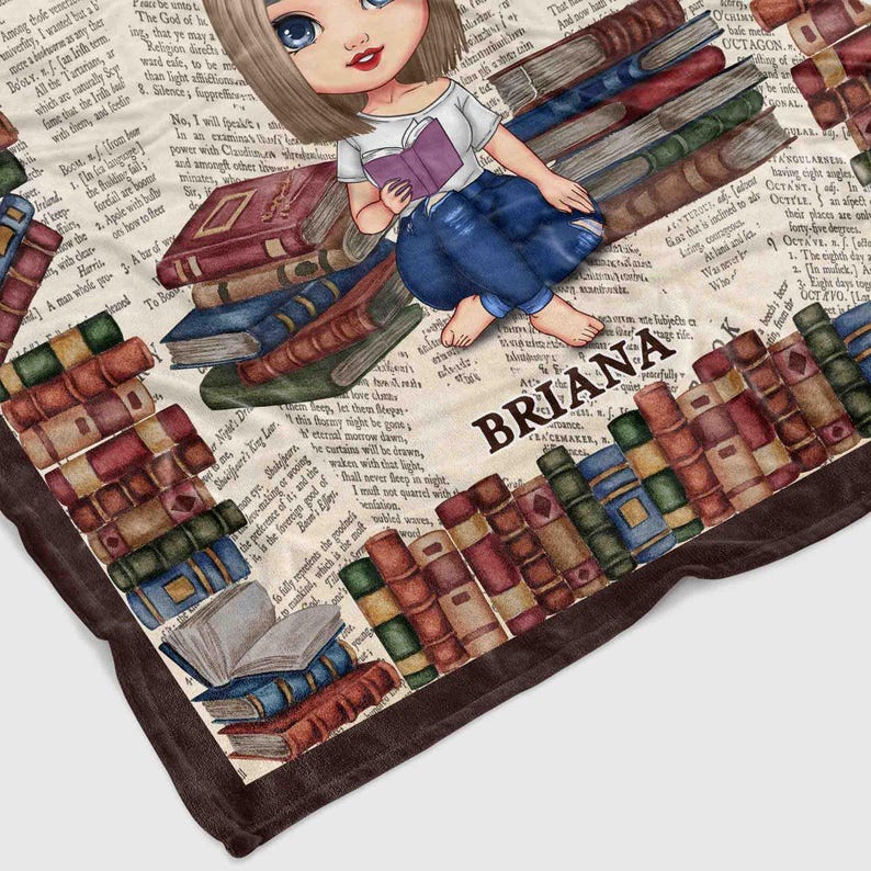 May include: A plush blanket featuring a cartoon illustration of a girl reading on a stack of books. The blanket has a vintage book and newspaper print background, with a border. The name "BRIANA" is printed on the blanket.