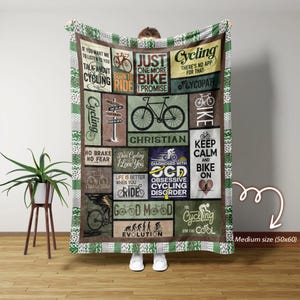 May include: A medium-sized cycling-themed blanket, 50x60 inches, featuring various cycling-related phrases and bicycle illustrations in a collage design. The blanket has a green and white patterned border.