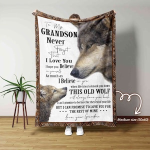 May include: A gray and brown wolf and a smaller wolf cub are pictured on a fleece blanket. The blanket has a message for a grandson, "To My GRANDSON Never Forget That I Love You I hope you Believe in yourself As much as I Believe in you when life tries to knock you down THIS OLD WOLF will always have your back I can't promise to be here for the rest of your life BUT I CAN PROMISE TO LOVE YOU FOR THE REST OF MINE... Love, your Grandma"