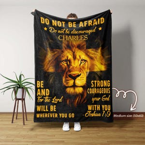 May include: Black blanket with a golden lion illustration and the text "DO NOT BE AFRAID" and "BE STRONG COURAGEOUS". The blanket is a medium size, 127x152 cm, and features a cross design.