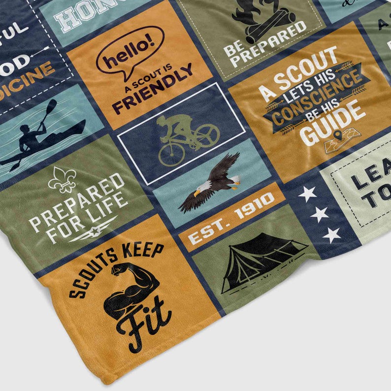May include: A colorful patchwork quilt with a variety of scout-themed designs, including a tent, a compass, a bicycle, and a canoe. The quilt features the text "Be Prepared", "A Scout is Friendly", "Prepared for Life", "A Scout Lets His Conscience Be His Guide", "Scouts Keep Fit", and "Est. 1910".