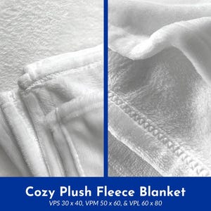 May include: Close-up of a white plush fleece blanket. The blanket has a soft, textured surface and is stitched along the edges. The text "Cozy Plush Fleece Blanket" is displayed in a blue banner at the bottom of the image. Sizes include 30 x 40 inches, 50 x 60 inches, and 60 x 80 inches.