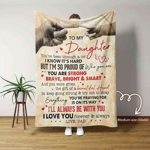 May include: A brown and tan fleece blanket with a message to a daughter. The message reads "To My Daughter You've been through a lot I know it's hard but I'm so proud of who you are You are strong brave, bright & smart And you were given the gift of a beautiful heart So keep going strong & try not to stray You're praying for everything is on its way I'll always be with you I love you forever & always Love, Dad". The blanket is medium size (50x60).