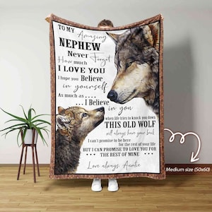 May include: A brown and tan fleece blanket with a wolf and wolf pup design. The blanket features the text "To my amazing nephew, Never forget how much I love you. I hope you believe in yourself as much as... I believe in you. When life tries to knock you down, this old wolf will always have your back. I can't promise to be here for the rest of your life, but I can promise to love you for the rest of mine. Love always, Auntie."