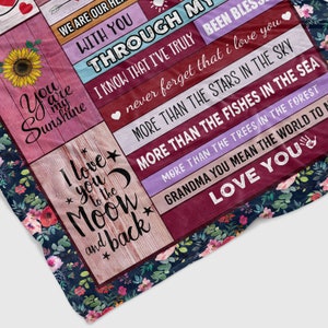 May include: A floral patterned blanket with a message of love and appreciation for a grandmother. The text reads "We are our hearts with you through my life I know that I've truly never forget that I love you more than the stars in the sky more than the fishes in the sea more than the trees in the forest Grandma you mean the world to me Love you".