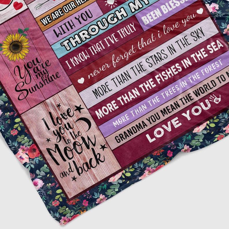 May include: A floral patterned blanket with a message of love and appreciation for a grandmother. The text reads "We are our hearts with you through my life I know that I've truly never forget that I love you more than the stars in the sky more than the fishes in the sea more than the trees in the forest Grandma you mean the world to me Love you".