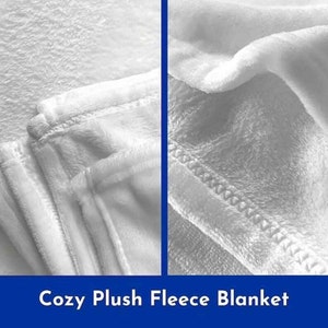 May include: Close-up of a white plush fleece blanket. The blanket is folded and shows the soft texture of the fabric. The blanket is described as "Cozy Plush Fleece Blanket".