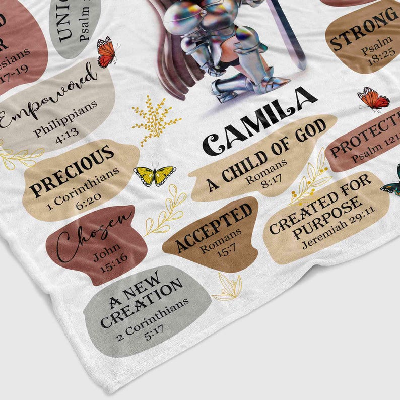 May include: A white blanket with a colorful design featuring a knight kneeling with a sword. The design includes the name "CAMILA" and various bible verses, including "A Child of God", "Strong", "Precious", "Chosen", "Accepted", "A New Creation", "Protected", and "Created for Purpose".