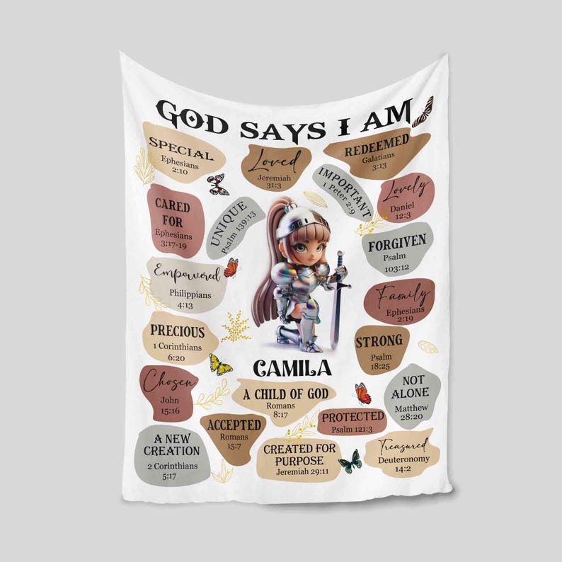 May include: A white blanket with a colorful design featuring a girl in armor and the words "God Says I Am" with bible verses. The girl is kneeling and holding a sword. The blanket is decorated with butterflies and flowers.