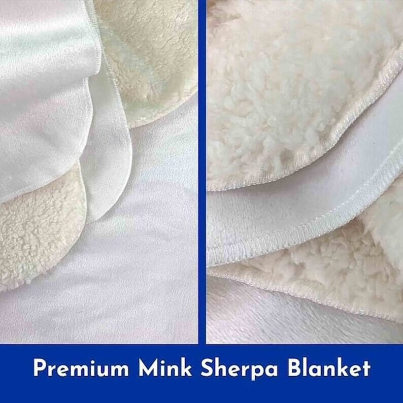 May include: Close-up of a white faux fur blanket with a soft, plush texture. The blanket is folded in half, revealing a smooth, white underside.  The text "Premium Mink Sherpa Blanket" is displayed at the bottom of the image.