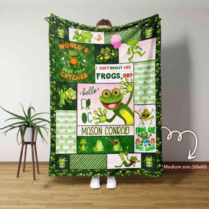 May include: Green fleece blanket with a frog theme. It features a variety of frogs, including a frog with the text "hello FR OG MASON CONRAD" and the text "WORLD'S BEST FROG CATCHER" and "I JUST REALLY LIKE FROGS, OK?" and "FROG ARE SPIRIT ANIMAL".