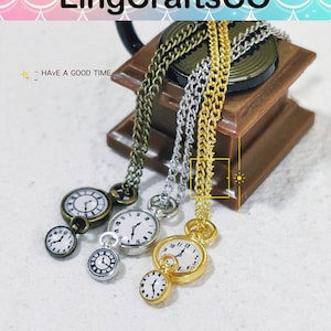 May include: Three gold, silver, and bronze pocket watch necklaces with chain links. The watches have white faces with black Roman numeral hour markers and black hands. The text "HAVE A GOOD TIME" is visible in the background.