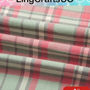 May include: A folded fabric featuring a plaid pattern in shades of sage green, red, and white with thin black intersecting lines. The text LingCraftsCO is visible at the top, and the number 2# is printed in white on a red rounded rectangle.