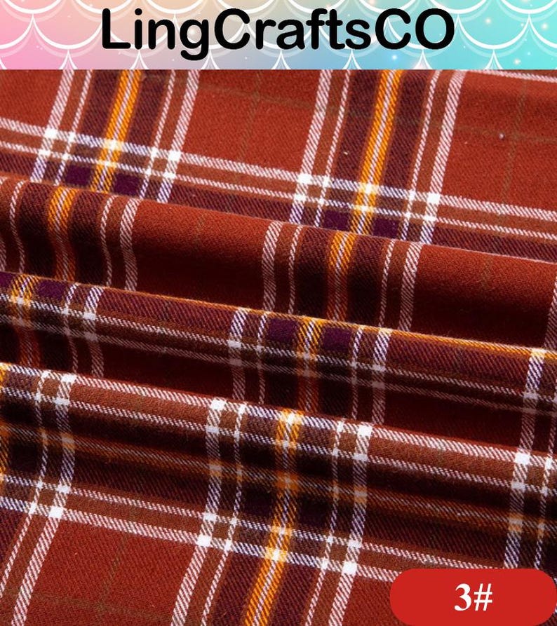 May include: A fabric with a rust-colored plaid pattern featuring thin white, yellow, and dark purple intersecting lines. The textile is folded, creating soft ripples across the surface. The text LingCraftsCO and 3# are visible.