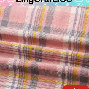 May include: A fabric featuring a plaid pattern in shades of pink, white, gray, and yellow. The textile has a soft, woven texture with visible folds and creases. The text LingCraftsCO is visible at the top, and the number 4# is in the bottom corner.