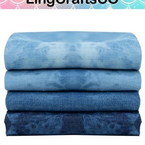 May include: A stack of four folded fabric pieces featuring a blue tie-dye pattern. The colors range from a light sky blue at the top to a deep navy blue at the bottom. Each piece of fabric displays a textured surface with a repeating pattern.