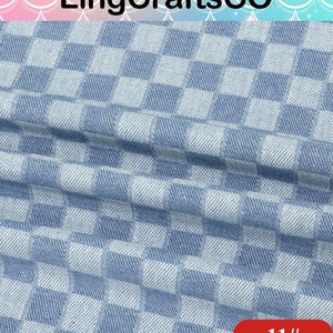 May include: A fabric featuring a repeating checkered pattern in light blue and white. The material has a visible woven texture with soft folds creating depth across the surface. The text LingCraftsCO appears at the top and 11# is in the corner.