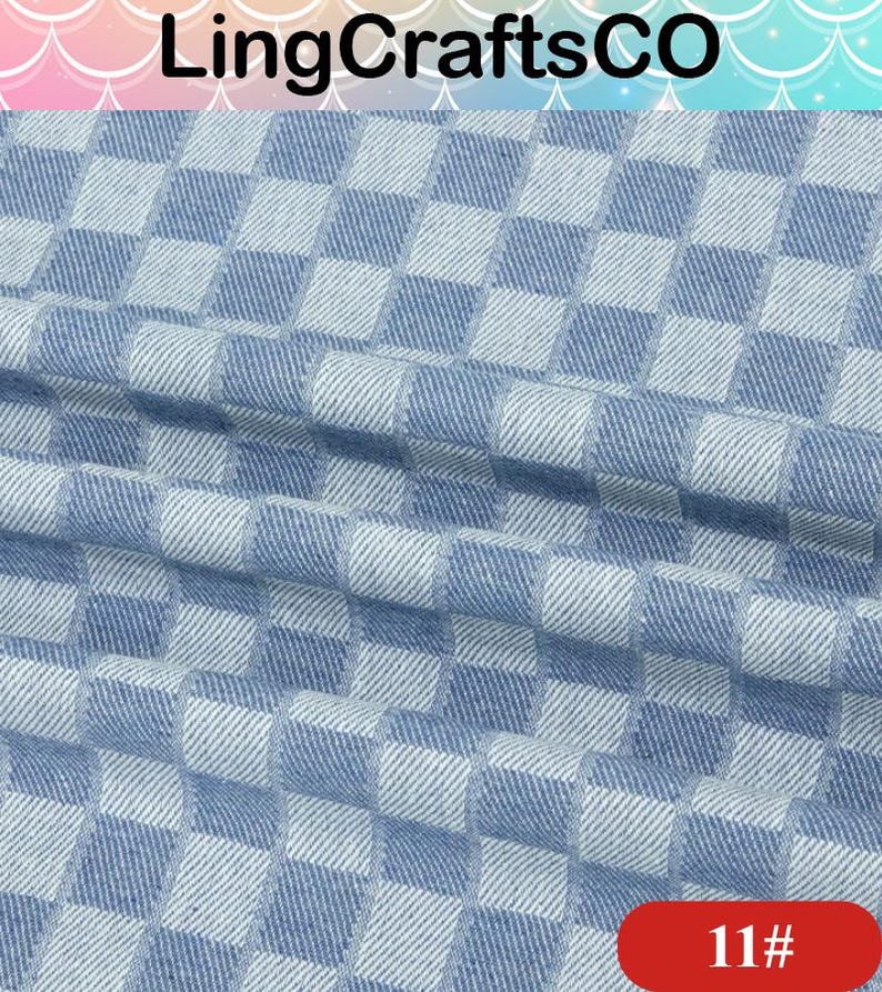 May include: A fabric featuring a repeating checkered pattern in light blue and white. The material has a visible woven texture with soft folds creating depth across the surface. The text LingCraftsCO appears at the top and 11# is in the corner.