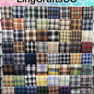 May include: A display of folded fabric squares featuring a wide variety of plaid and tartan patterns in numerous color combinations including brown, blue, green, yellow, red, black, and white. The text LingCraftsCO is visible at the top.