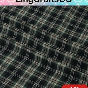 May include: A fabric featuring a dark green, black, and beige plaid pattern with thin white intersecting lines. The material is folded, creating soft ripples and shadows across the surface. The text LingCraftsCO and 12# are visible.