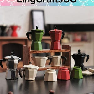May include: A set of miniature coffee pots in various colors, including red, green, black, and silver. The pots are arranged on a wooden shelf and a black surface. The pots are made of metal and ceramic.