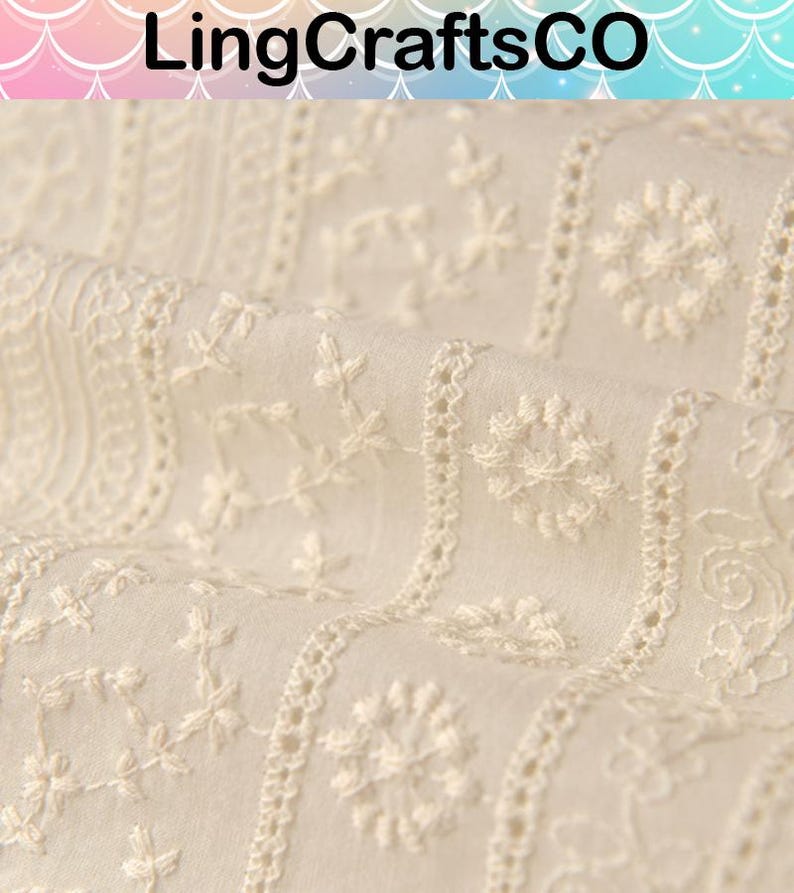 May include: Off-white fabric featuring vertical stripes of intricate white floral and geometric embroidery. The textile displays a repeating pattern of small blossoms, vines, and circular motifs. The text LingCraftsCO is visible at the top.
