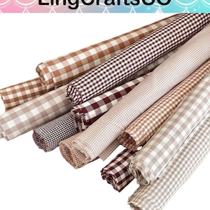 May include: Multiple rolls of fabric featuring various gingham check patterns in shades of brown, tan, and white. The rolls are arranged in a cluster, displaying different sizes of checkered prints, with the text LingCraftsCO visible at the top.