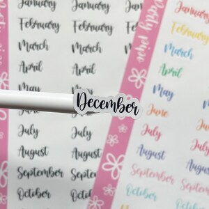 May include: A sheet of stickers with the months of the year written in cursive. The stickers are on a white background with pink, blue, yellow, and green borders. The word "Party Time" is written on the left side of the sheet and the word "Party Time" is written on the right side of the sheet.
