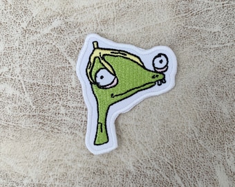 Broderad stryklapp med tecknad monster