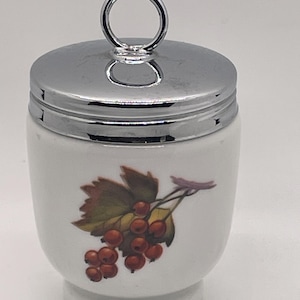 May include: A white ceramic mug with a black handle and the text "But First, Coffee" in a handwritten style. The mug is likely for hot beverages and has a glossy finish.