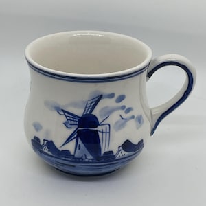 May include: A set of three ceramic mugs with a speckled, matte finish. The mugs are in shades of cream, light gray, and dark gray. Each mug has a simple, modern design and a rounded handle.