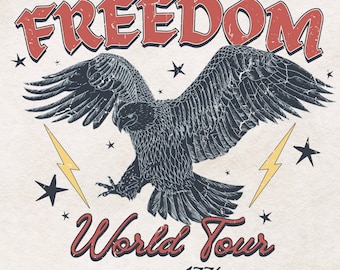 May include: A distressed graphic design featuring a black eagle with outstretched wings, flying above a lightning bolt. The text "FREEDOM World Tour since 1776" is written in red and white lettering.