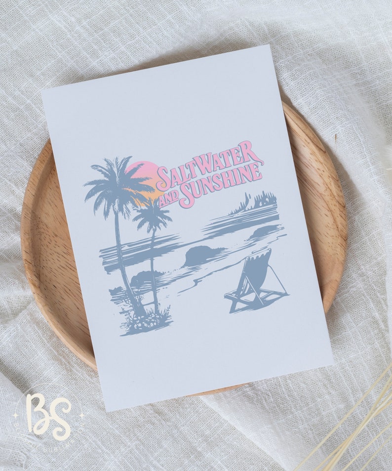 May include: A light blue print with a beach scene and the text "Saltwater and Sunshine" in pink. The scene includes palm trees, a beach, a sunset, and a beach chair.
