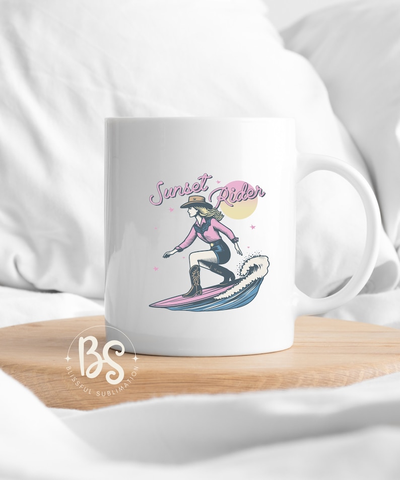 White ceramic mug with a Surfing Cowgirl design, featuring a stylish cowgirl riding a surfboard with the text "Sunset Rider," perfect for sublimation projects.
